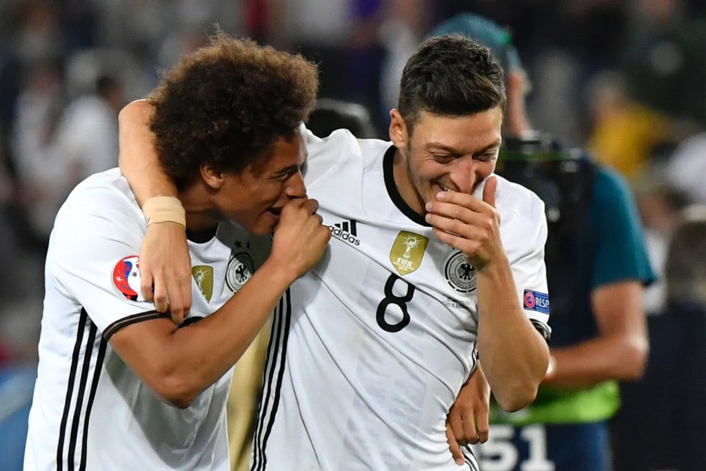 Germany's midfielder Mesut Oezil (R) and Germany's midfielder Leroy Sane celebrate after winning the Euro 2016 quarter-final football match between Germany and Italy at the Matmut Atlantique stadium in Bordeaux on July 2, 2016. (Photo credit: Georges Gobet/AFP/Getty Images)