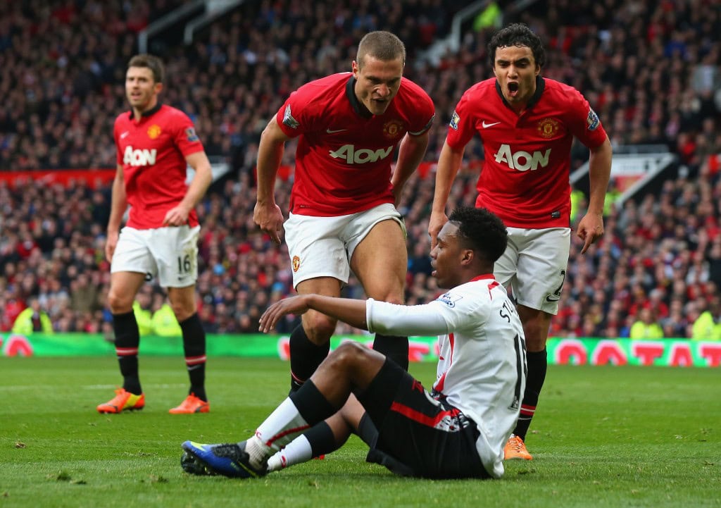MANCHESTER, ENGLAND - MARCH 16: Nemanja Vidic of Manchester United and Rafael (R) react to Daniel Sturridge of Liverpool after the award of the second penalty kick during the Barclays Premier League match between Manchester United and Liverpool at Old Trafford on March 16, 2014 in Manchester, England. (Photo by Alex Livesey/Getty Images)