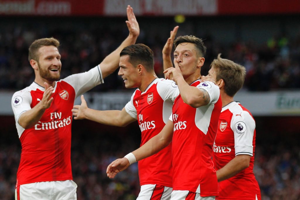 rsenal's German midfielder Mesut Ozil celebrates scoring their third goal during the English Premier League football match between Arsenal and Chelsea at The Emirates stadium in London, on September 24, 2016. / AFP / IKIMAGES / Ian KINGTON / RESTRICTED TO EDITORIAL USE. No use with unauthorized audio, video, data, fixture lists, club/league logos or 'live' services. Online in-match use limited to 45 images, no video emulation. No use in betting, games or single club/league/player publications. (Photo credit should read IAN KINGTON/AFP/Getty Images)
