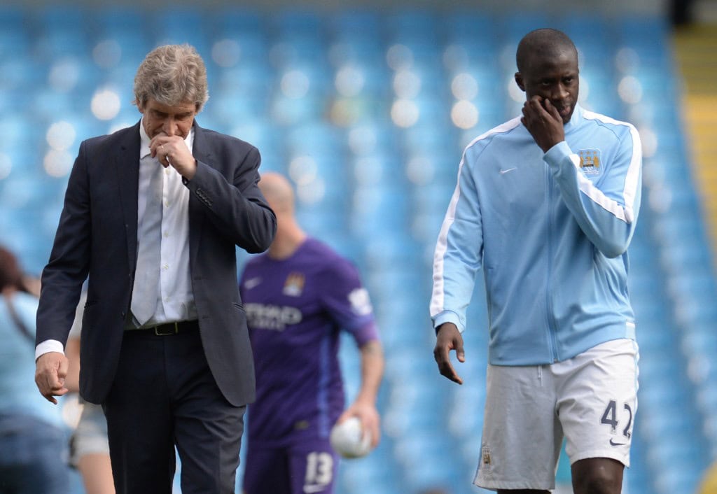 Manchester City's Chilean manager Manuel Pellegrini (L) and Manchester City's Ivorian midfielder and captain Yaya Toure walk on the pitch after the English Premier League football match between Manchester City and Arsenal at the Etihad Stadium in Manchester, north west England, on May 8, 2016. / AFP / OLI SCARFF / RESTRICTED TO EDITORIAL USE. No use with unauthorized audio, video, data, fixture lists, club/league logos or 'live' services. Online in-match use limited to 75 images, no video emulation. No use in betting, games or single club/league/player publications. / (Photo credit should read OLI SCARFF/AFP/Getty Images)