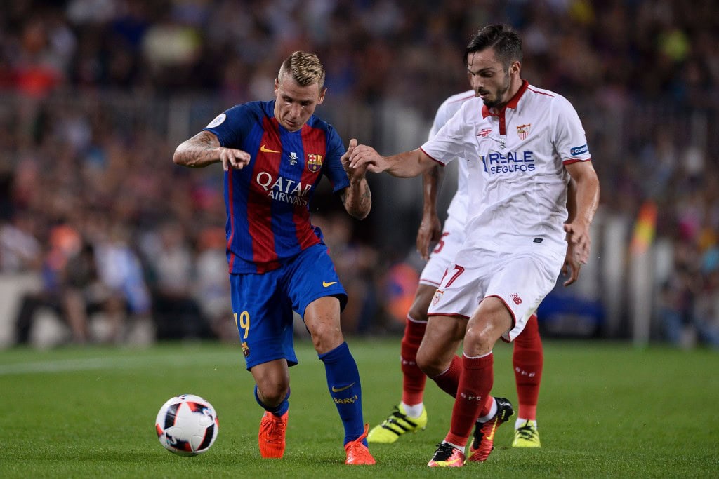 Barcelona's French defender Lucas Digne (L) vies with Sevilla's midfielder Pablo Sarabia during the second leg of the Spanish Supercup football match between FC Barcelona and Sevilla FC at the Camp Nou stadium in Barcelona on August 17, 2016. / AFP / JOSEP LAGO (Photo credit should read JOSEP LAGO/AFP/Getty Images)