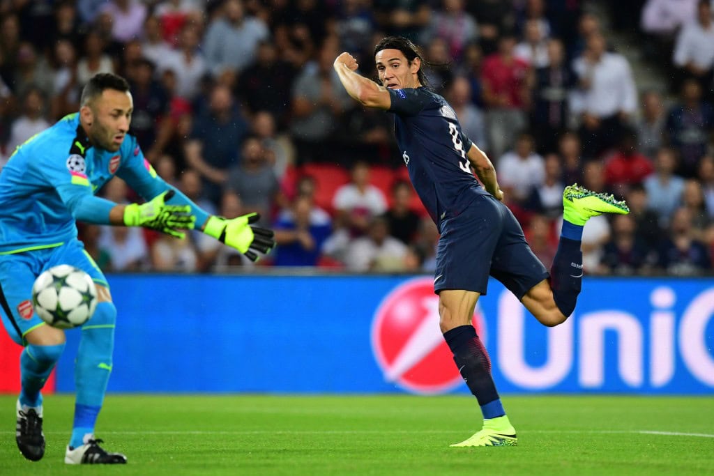 Paris Saint-Germain's Uruguayan forward Edinson Cavani (R) shoots to score despite of Arsenal's Colombian goalkeeper David Ospina (L) during the UEFA Champions League Group A football match between Paris-Saint-Germain vs Arsenal FC, on September 13, 2016 at the Parc des Princes stadium in Paris. AFP PHOTO / FRANCK FIFFE