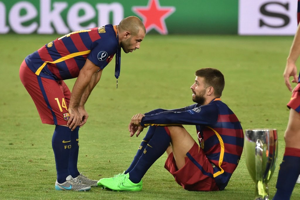 Barcelona's Spanish defender Gerard Pique and Barcelona's Argentinian defender Javier Mascherano (L) react after winning the UEFA Super Cup final football match between FC Barcelona and Sevilla FC on August 11, 2015 at the Boris Paichadze Dinamo Arena in Tbilisi. AFP PHOTO / KIRILL KUDRYAVTSEV (Photo credit should read KIRILL KUDRYAVTSEV/AFP/Getty Images)