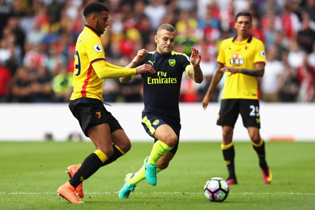 WATFORD, ENGLAND - AUGUST 27: Etienne Capoue of Watford (L) and Jack Wilshere of Arsenal (C) both challenge for the ball during the Premier League match between Watford and Arsenal at Vicarage Road on August 27, 2016 in Watford, England. (Photo by Christopher Lee/Getty Images)
