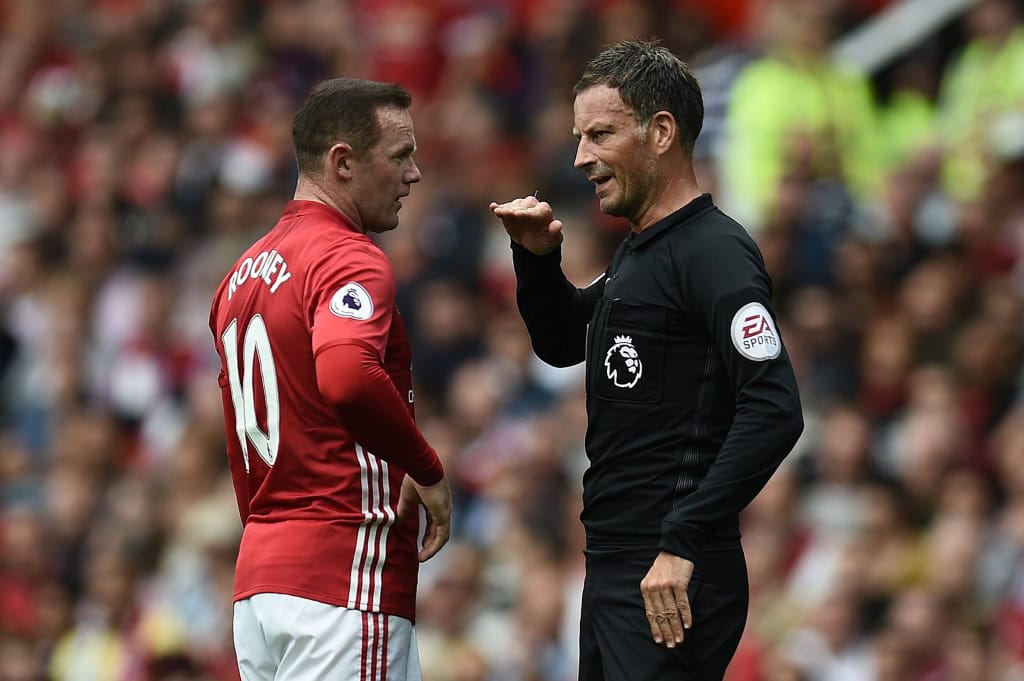 Manchester United's English striker Wayne Rooney (L) is spoken to by referee Mark Clattenburg during the English Premier League football match between Manchester United and Manchester City at Old Trafford in Manchester, north west England, on September 10, 2016. / AFP / Oli SCARFF / RESTRICTED TO EDITORIAL USE. No use with unauthorized audio, video, data, fixture lists, club/league logos or 'live' services. Online in-match use limited to 75 images, no video emulation. No use in betting, games or single club/league/player publications. / (Photo credit should read OLI SCARFF/AFP/Getty Images)