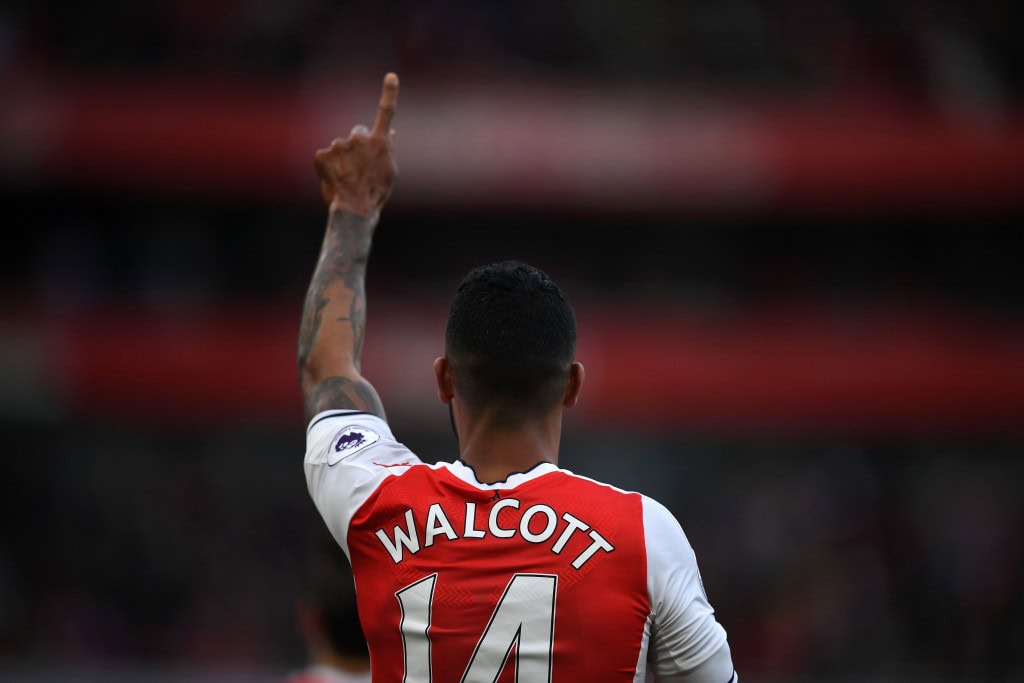 Arsenal's English midfielder Theo Walcott celebrates scoring the opening goal of the English Premier League football match between Arsenal and Swansea City at the Emirates Stadium in London on October 15, 2016. Arsenal won the game 3-2. / AFP / Justin TALLIS / RESTRICTED TO EDITORIAL USE. No use with unauthorized audio, video, data, fixture lists, club/league logos or 'live' services. Online in-match use limited to 75 images, no video emulation. No use in betting, games or single club/league/player publications. / (Photo credit should read JUSTIN TALLIS/AFP/Getty Images)