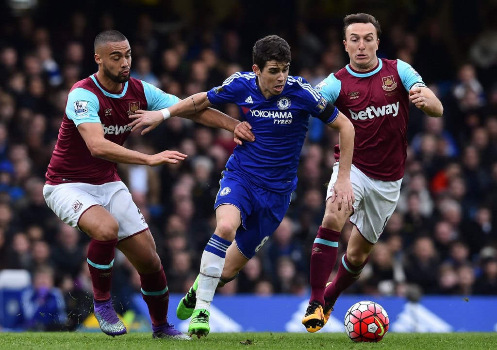 Chelsea's Brazilian midfielder Oscar (C) vies with West Ham United's New Zealand defender Winston Reid (L) and West Ham United's English midfielder Mark Noble during the English Premier League football match between Chelsea and West Ham United at Stamford Bridge in London on March 19, 2016. The game finished 2-2. / AFP / Ben STANSALL / RESTRICTED TO EDITORIAL USE. No use with unauthorized audio, video, data, fixture lists, club/league logos or 'live' services. Online in-match use limited to 75 images, no video emulation. No use in betting, games or single club/league/player publications. / (Photo credit should read BEN STANSALL/AFP/Getty Images)
