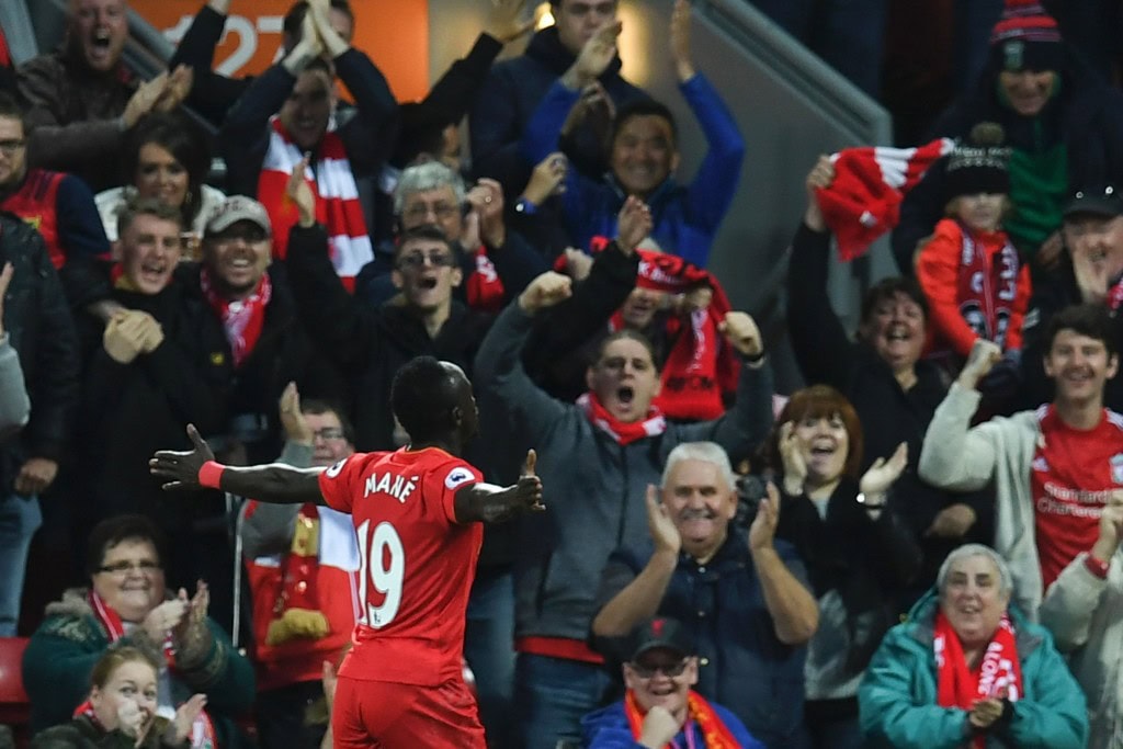 Liverpool's Senegalese midfielder Sadio Mane celebrates scoring the opening goal during the English Premier League football match between Liverpool and West Bromwich Albion at Anfield in Liverpool, north west England on October 22, 2016. / AFP / PAUL ELLIS / RESTRICTED TO EDITORIAL USE. No use with unauthorized audio, video, data, fixture lists, club/league logos or 'live' services. Online in-match use limited to 75 images, no video emulation. No use in betting, games or single club/league/player publications. / (Photo credit should read PAUL ELLIS/AFP/Getty Images)