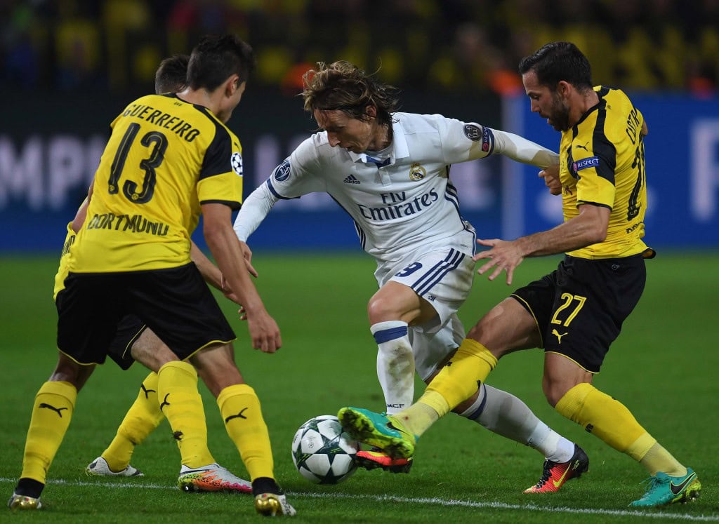Dortmund's midfielder Gonzalo Castro (R) and Dortmund's Portuguese defender Raphael Guerreiro vie with Real Madrid's Croatian midfielder Luka Modric during the UEFA Champions League first leg football match between Borussia Dortmund and Real Madrid at BVB stadium in Dortmund, on September 27, 2016. / AFP / PATRIK STOLLARZ (Photo credit should read PATRIK STOLLARZ/AFP/Getty Images)