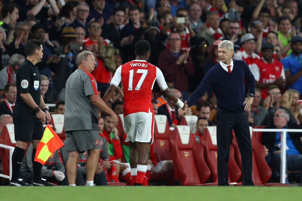 LONDON, ENGLAND - SEPTEMBER 24: Alex Iwobi of Arsenal (L) and Arsene Wenger, Manager of Arsenal (R) shake hands after he is subbed during the Premier League match between Arsenal and Chelsea at the Emirates Stadium on September 24, 2016 in London, England. (Photo by Paul Gilham/Getty Images)