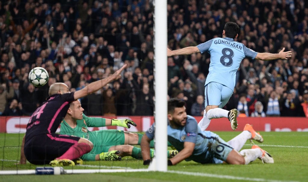 Manchester City's German midfielder Ilkay Gundogan (R) celebrates scoring his team's third goal during the UEFA Champions League group C football match between Manchester City and Barcelona at the Etihad Stadium in Manchester, north west England on November 1, 2016. (Photo by OLI SCARFF/AFP/Getty Images)