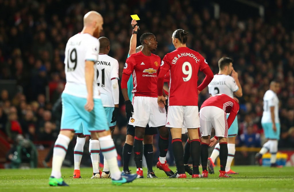 MANCHESTER, ENGLAND - NOVEMBER 27: Paul Pogba of Manchester United (C) is shown a yellow card during the Premier League match between Manchester United and West Ham United at Old Trafford on November 27, 2016 in Manchester, England. (Photo by Alex Livesey/Getty Images)