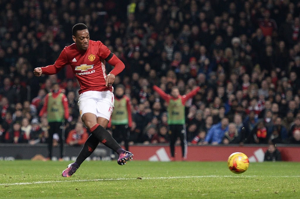 Manchester United's French striker Anthony Martial scores his team's third goal during the EFL (English Football League) Cup quarter-final football match between Manchester United and West Ham United at Old Trafford in Manchester, north west England, on November 30, 2016 (Photo by OLI SCARFF/AFP/Getty Images)
