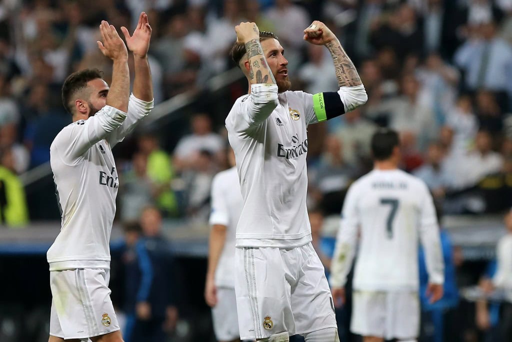 Real Madrid's defender Dani Carvajal (L) and Real Madrid's defender Sergio Ramos celebrate their victory at the end the UEFA Champions League semi-final second leg football match Real Madrid CF vs Manchester City FC at the Santiago Bernabeu stadium in Madrid, on May 4, 2016. Real Madrid won 1-0. / AFP / CESAR MANSO (Photo credit should read CESAR MANSO/AFP/Getty Images)