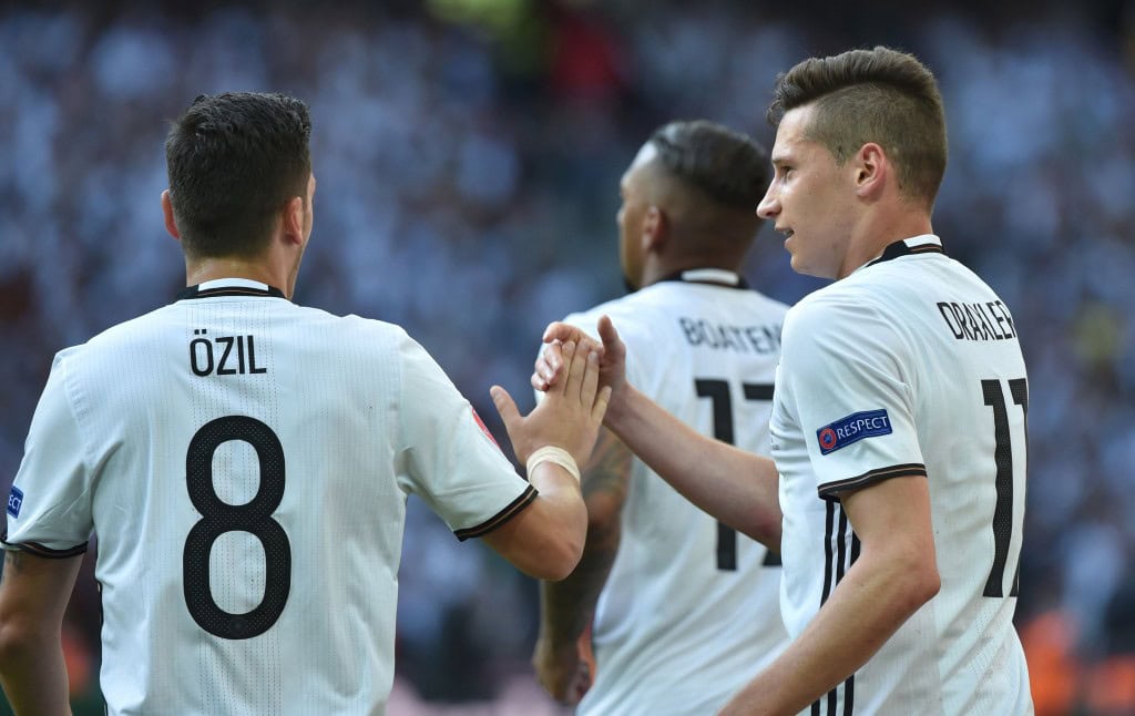 Germany's midfielder Julian Draxler (R) celebrates with Germany's midfielder Mesut Oezil after scoring during the Euro 2016 round of 16 football match between Germany and Slovakia at the Pierre-Mauroy stadium in Villeneuve-d'Ascq, near Lille, on June 26, 2016. / AFP / PHILIPPE HUGUEN (Photo credit should read PHILIPPE HUGUEN/AFP/Getty Images)
