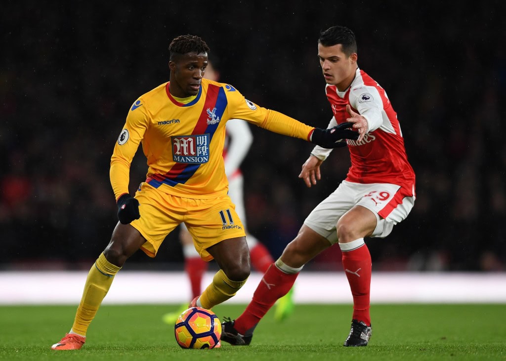 LONDON, ENGLAND - JANUARY 01: Wilfried Zaha of Crystal Palace is challenged by Granit Xhaka of Arsenal during the Premier League match between Arsenal and Crystal Palace at the Emirates Stadium on January 1, 2017 in London, England. (Photo by Shaun Botterill/Getty Images)