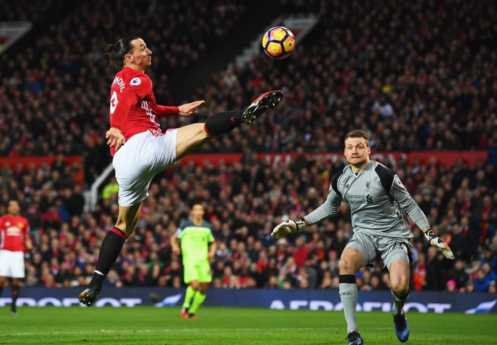 MANCHESTER, ENGLAND - JANUARY 15: Zlatan Ibrahimovic of Manchester United stretches for the ball as Simon Mignolet of Liverpool looks on during the Premier League match between Manchester United and Liverpool at Old Trafford on January 15, 2017 in Manchester, England. (Photo by Laurence Griffiths/Getty Images)