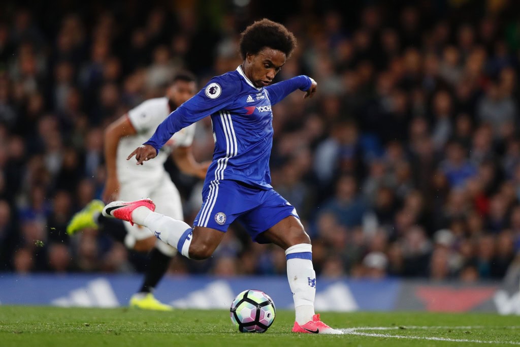 Chelsea's Brazilian midfielder Willian takes a shot but misses during the English Premier League football match between Chelsea and Watford at Stamford Bridge in London on May 15, 2017. / AFP PHOTO / Adrian DENNIS / RESTRICTED TO EDITORIAL USE. No use with unauthorized audio, video, data, fixture lists, club/league logos or 'live' services. Online in-match use limited to 75 images, no video emulation. No use in betting, games or single club/league/player publications. / (Photo credit should read ADRIAN DENNIS/AFP/Getty Images)