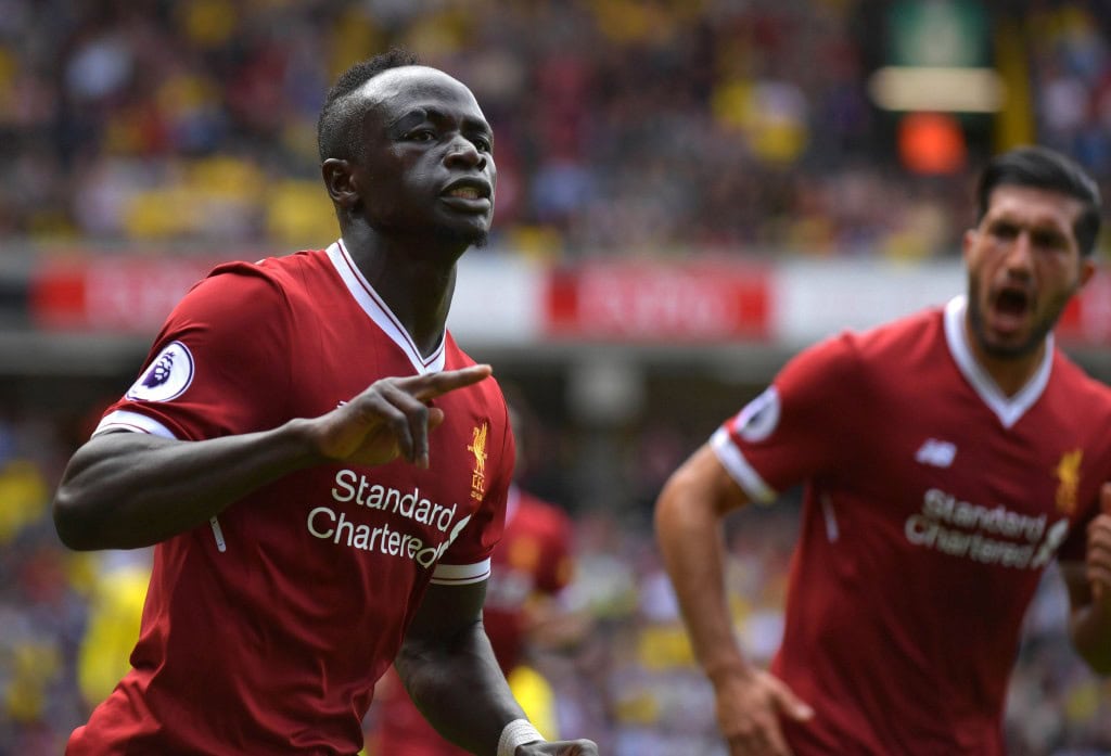 Liverpool's Senegalese midfielder Sadio Mane (l) celebrates scoring his team's second goal during the English Premier League football match between Watford and Liverpool at Vicarage Road Stadium in Watford, north of London on August 12, 2017. / AFP PHOTO / OLLY GREENWOOD / RESTRICTED TO EDITORIAL USE. No use with unauthorized audio, video, data, fixture lists, club/league logos or 'live' services. Online in-match use limited to 75 images, no video emulation. No use in betting, games or single club/league/player publications. / (Photo credit should read OLLY GREENWOOD/AFP/Getty Images)