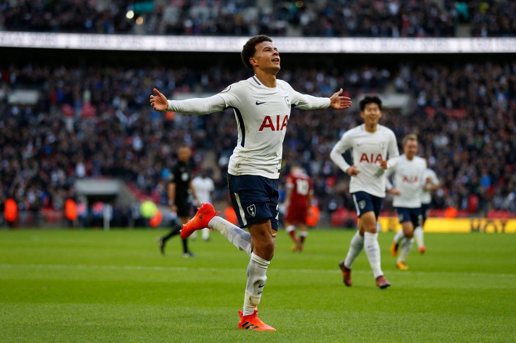 Tottenham Hotspur's English midfielder Dele Alli celebrates after scoring their third goal during the English Premier League football match between Tottenham Hotspur and Liverpool at Wembley Stadium in London, on October 22, 2017. / AFP PHOTO / IKIMAGES / Ian KINGTON / RESTRICTED TO EDITORIAL USE. No use with unauthorized audio, video, data, fixture lists, club/league logos or 'live' services. Online in-match use limited to 45 images, no video emulation. No use in betting, games or single club/league/player publications. / (Photo credit should read IAN KINGTON/AFP/Getty Images)
