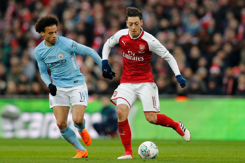 Manchester City's German midfielder Leroy Sane (L) vies with Arsenal's German midfielder Mesut Ozil during the English League Cup final football match between Manchester City and Arsenal at Wembley stadium in north London on February 25, 2018. / AFP PHOTO / Adrian DENNIS / RESTRICTED TO EDITORIAL USE. No use with unauthorized audio, video, data, fixture lists, club/league logos or 'live' services. Online in-match use limited to 75 images, no video emulation. No use in betting, games or single club/league/player publications. / (Photo credit should read ADRIAN DENNIS/AFP/Getty Images)