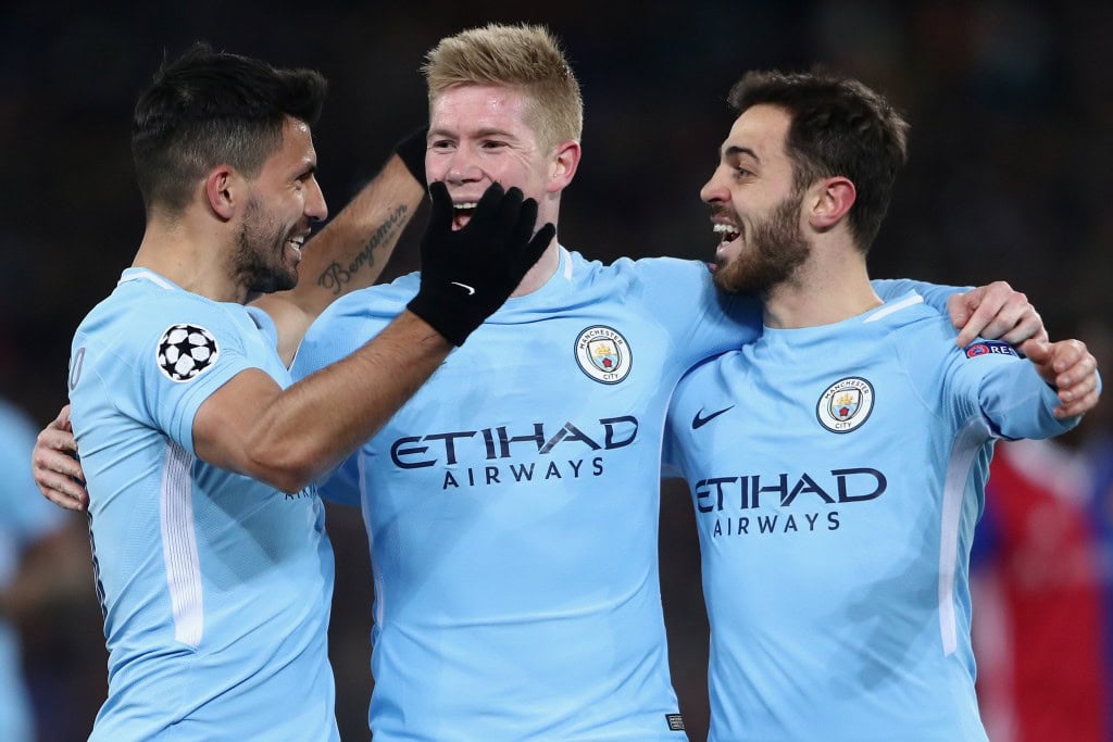 BASEL, SWITZERLAND - FEBRUARY 13: Sergio Aguero of Manchester celebrates his team's third goal with team mates Kevin de Bruyne and Bernardo Silva (L-R) during the UEFA Champions League Round of 16 First Leg match between FC Basel and Manchester City at St. Jakob-Park on February 13, 2018 in Basel, Switzerland. (Photo by Alex Grimm/Bongarts/Getty Images )