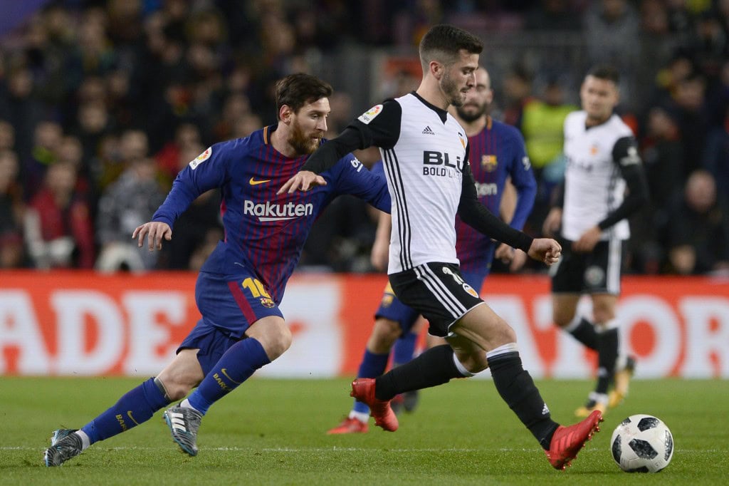 Barcelona's Argentinian forward Lionel Messi (L) vies with Valencia's Spanish defender Jose Luis Gaya Pena during the Spanish 'Copa del Rey' (King's cup) first leg semi-final football match between FC Barcelona and Valencia CF at the Camp Nou stadium in Barcelona on February 01, 2018. / AFP PHOTO / Josep LAGO (Photo credit should read JOSEP LAGO/AFP/Getty Images)