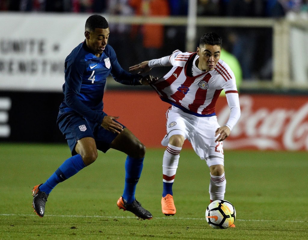 CARY, NC - MARCH 27: Tyler Adams #4 of United States grabs Miguel Almiron #23 of Paraguay as they battle for the ball during their game at WakeMed Soccer Park on March 27, 2018 in Cary, North Carolina. (Photo by Grant Halverson/Getty Images)