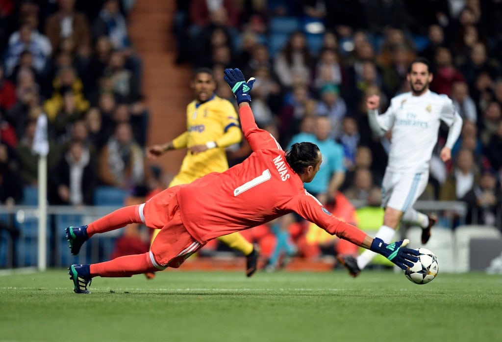 Real Madrid's Costa Rican goalkeeper Keylor Navas dives for the ball during the UEFA Champions League quarter-final second leg football match between Real Madrid CF and Juventus FC at the Santiago Bernabeu stadium in Madrid on April 11, 2018. / AFP PHOTO / OSCAR DEL POZO (Photo credit should read OSCAR DEL POZO/AFP/Getty Images)