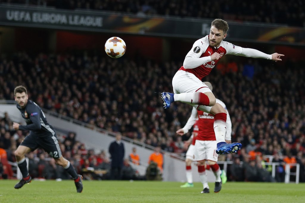 Arsenal's Welsh midfielder Aaron Ramsey scores their third goal with this flick during the UEFA Europa League first leg quarter-final football match between Arsenal and CSKA Moscow at the Emirates Stadium in London on April 5, 2018. / AFP PHOTO / IKIMAGES / Ian KINGTON (Photo credit should read IAN KINGTON/AFP/Getty Images)