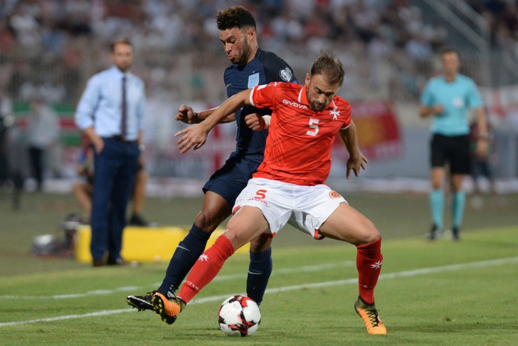England' Alex Oxlade-Chamberlain (L) vies with Malta's Andrei Agius during the 2018 FIFA World Cup qualifying football match Malta vs England at the National Stadium in Malta's Ta' Qali village, on September 1, 2017. / AFP PHOTO / Matthew Mirabelli / Malta OUT (Photo credit should read MATTHEW MIRABELLI/AFP/Getty Images)