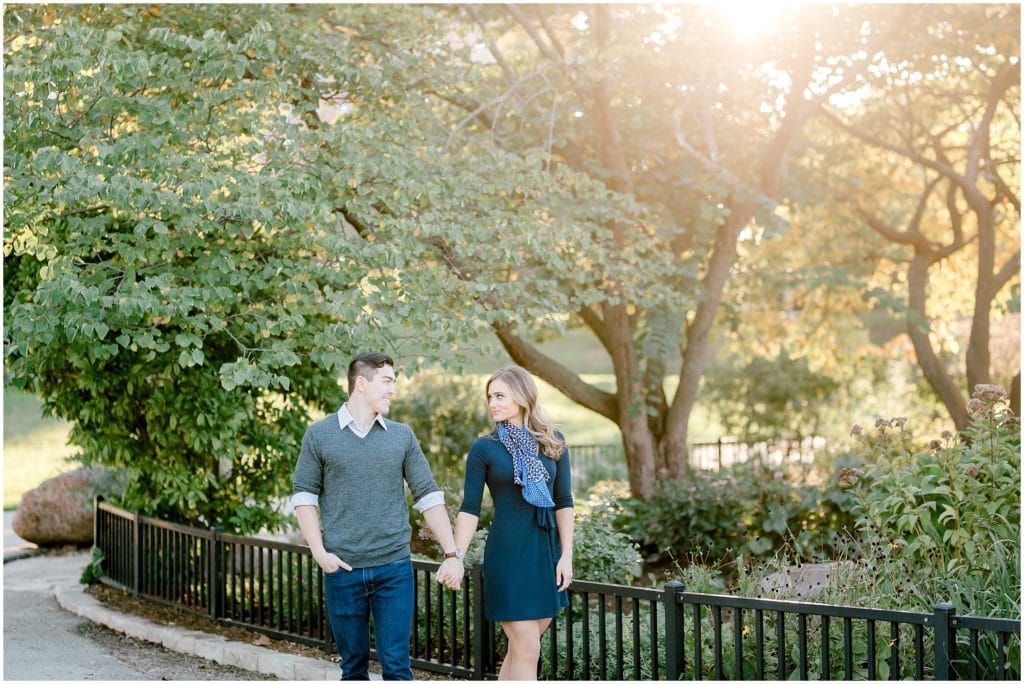 couple walking in the Chicago Lincoln Park during golden hour engagement session