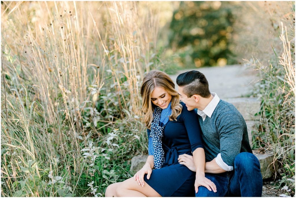 laughing couple on engagement session during sunset in Chicago Lincoln Park Zoo
