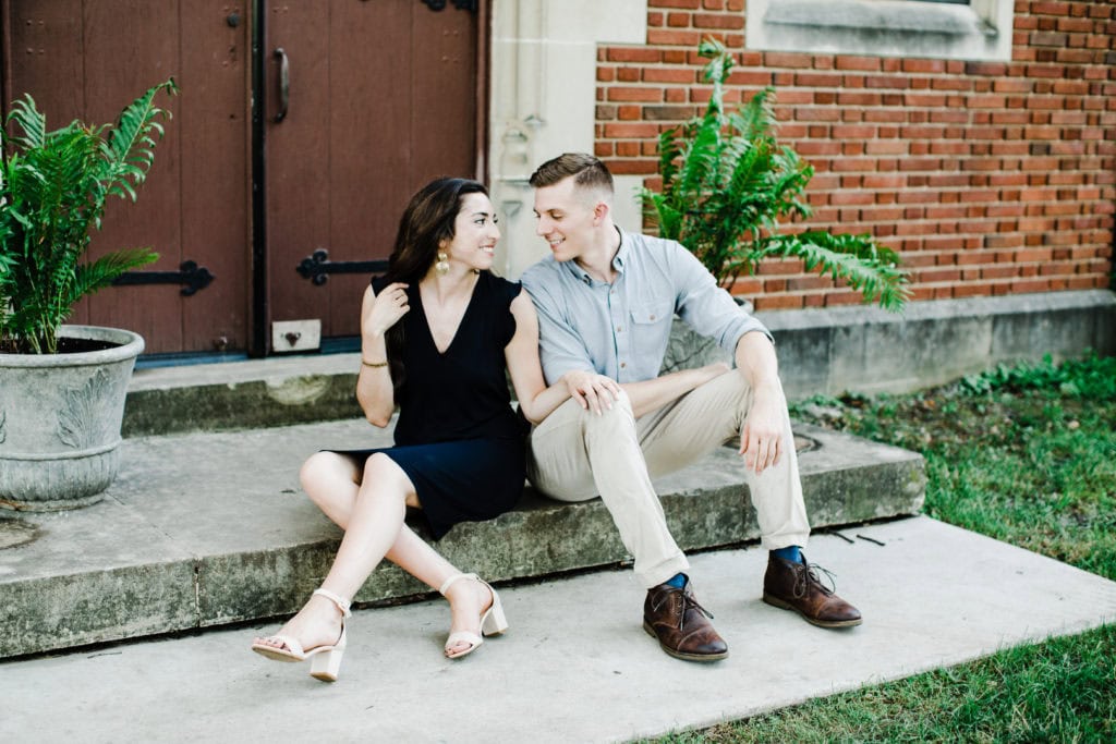 chicago engagement session of couple sitting on the stairs looking at each other