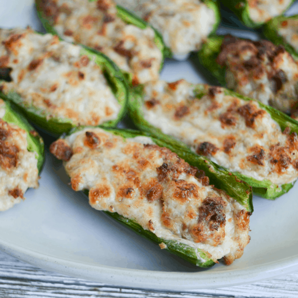Finished Philly Cheesesteak Jalapeno Poppers, cooked in the air fryer, sitting on a white plate