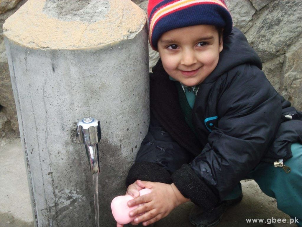 A Hunza kid washing hands