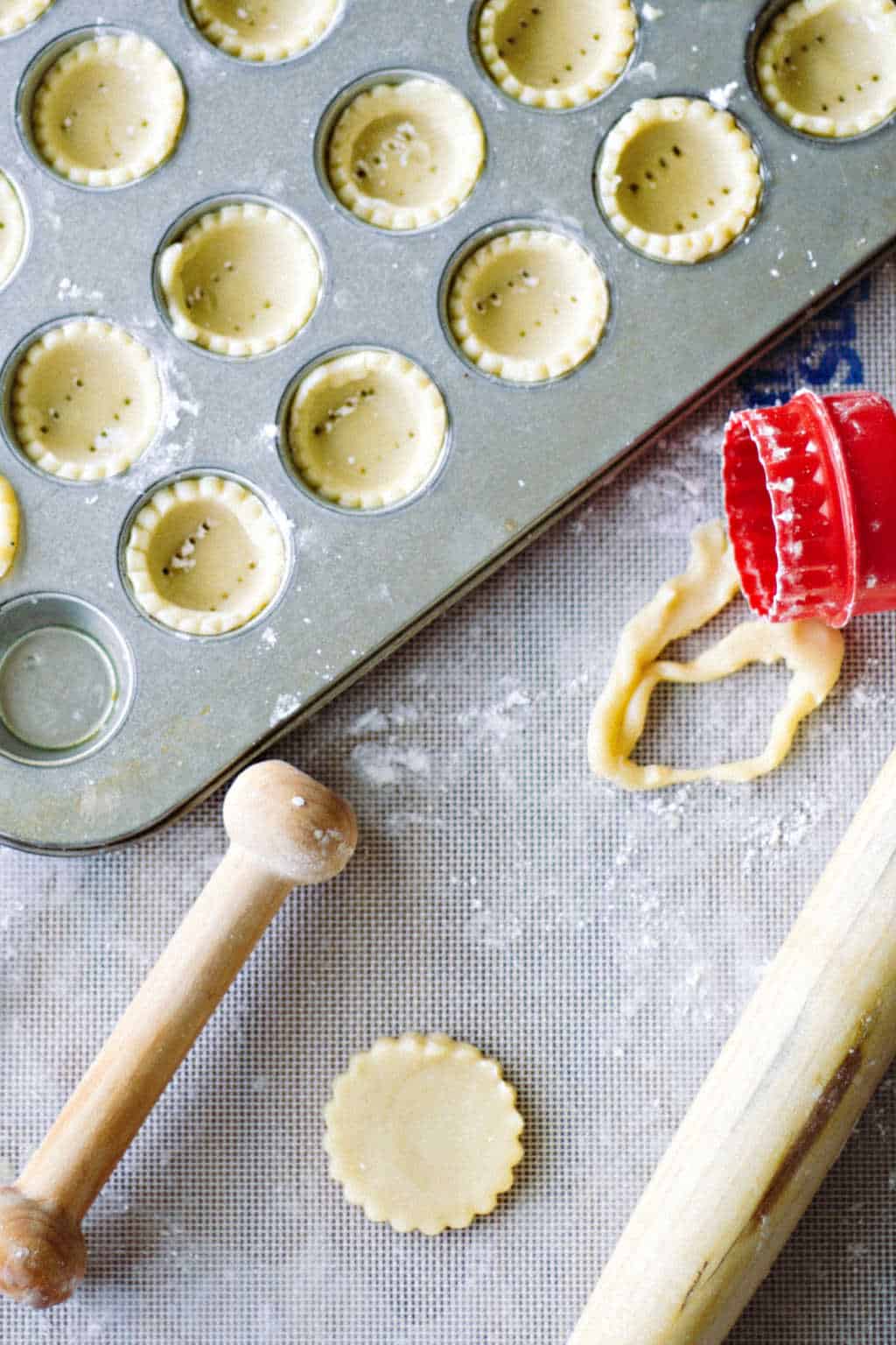 preparing miniature tart shells in a muffin tin