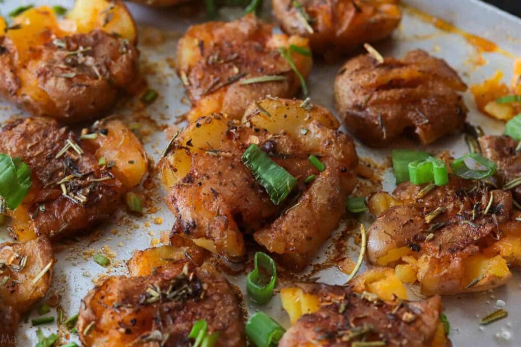 Baked Crispy smashed potatoes with herbs ready to eat