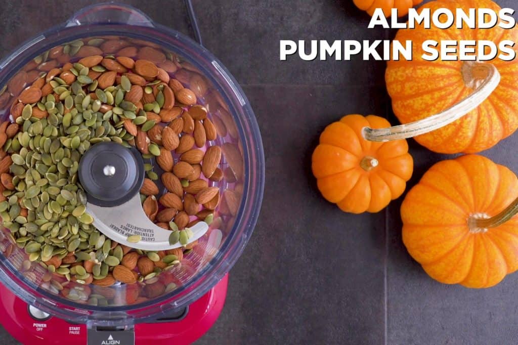 Pulse almonds and pumpkin seeds in food processor until finely chopped.