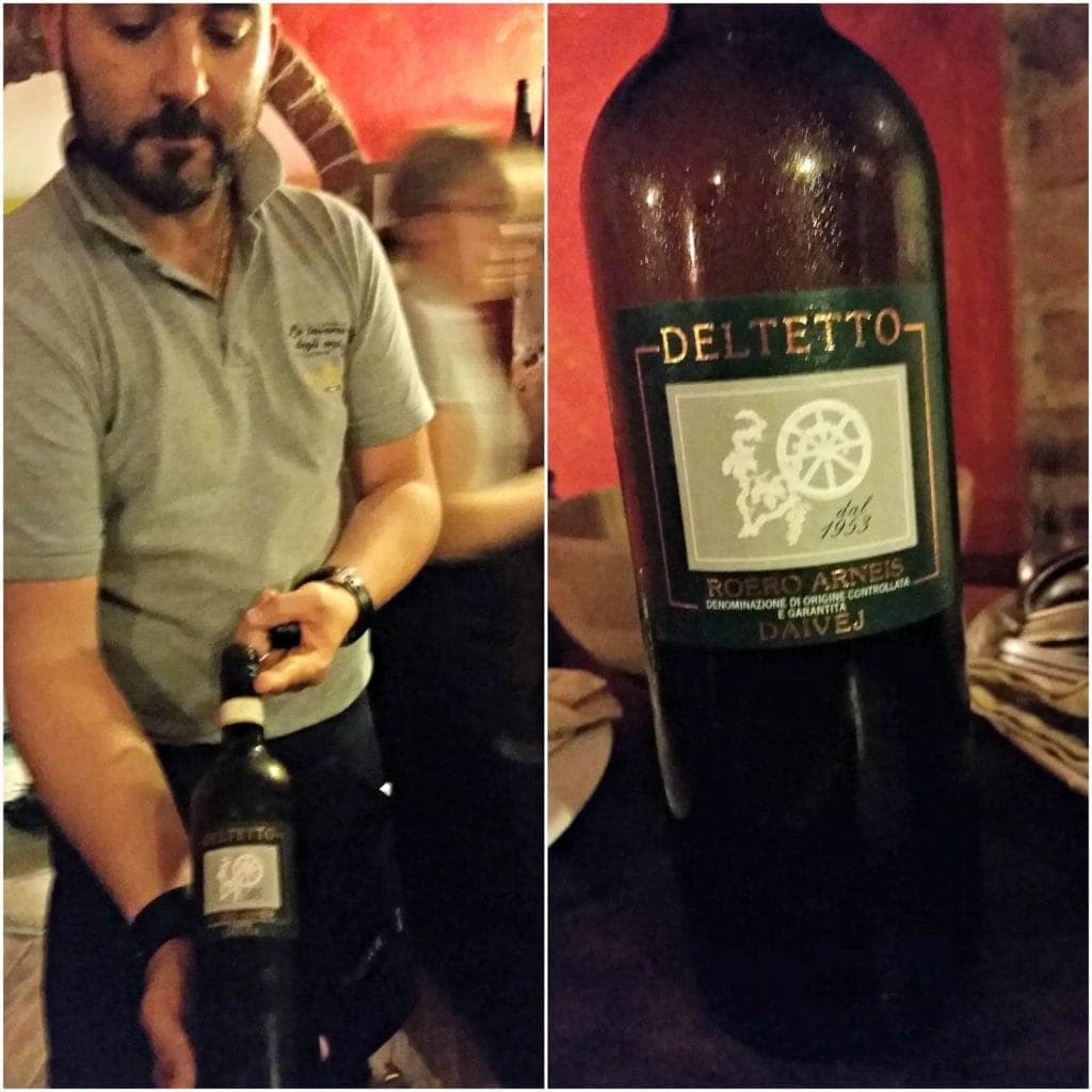 Owner Prince shows wine label to camera and close up of Deltetto Winery label