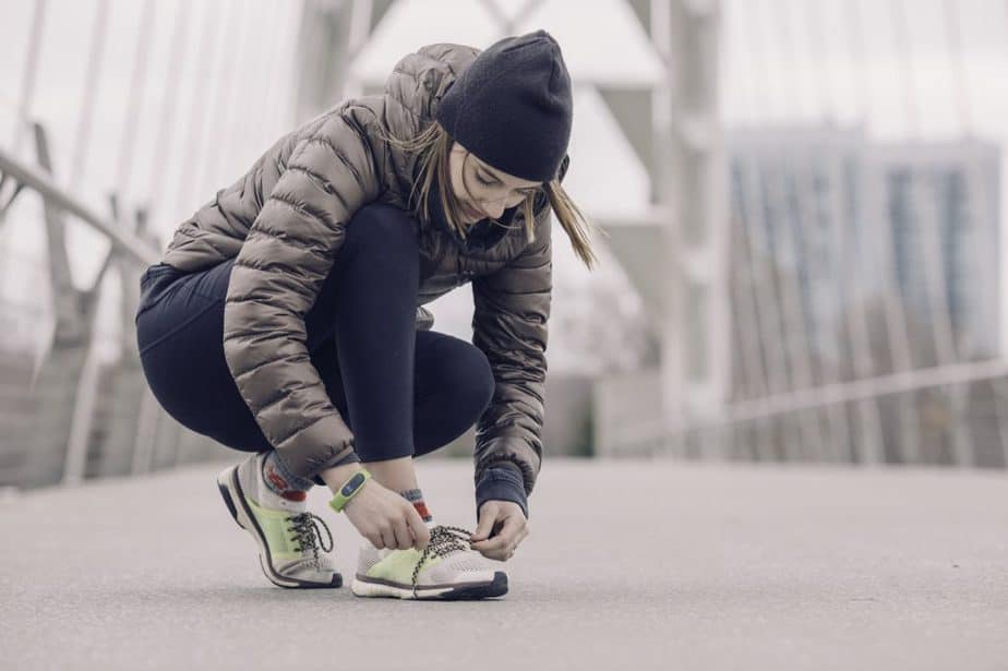 a runner tying her shoelaces