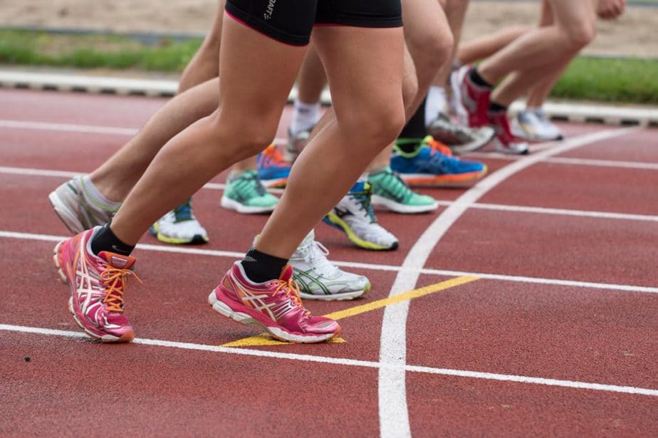 athletes running a race, only their legs, shorts and sports sneakers are shown