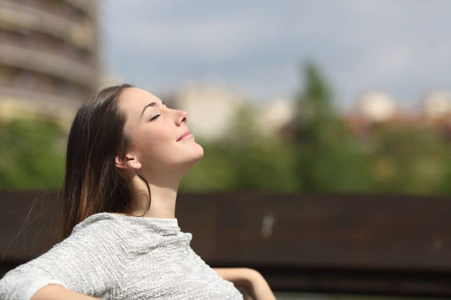 A girl is having a fresh air breathing outside