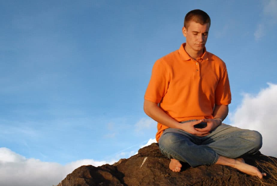 zen meditation - a man meditating outside