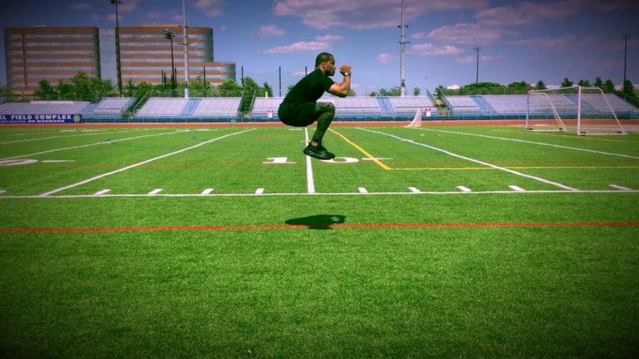 A guy has a tuck jumps training