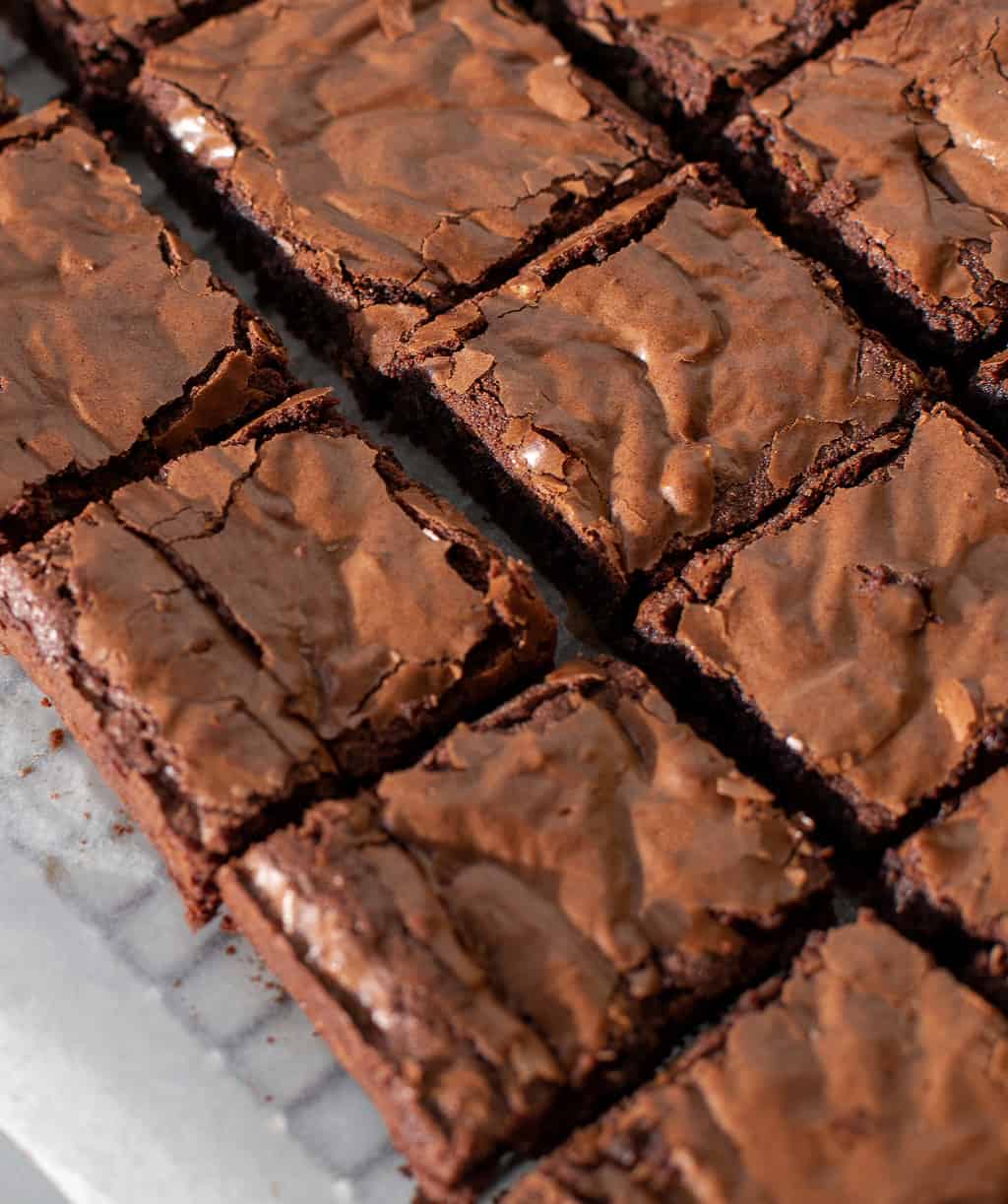 Coconut flour keto brownies on a parchment lined baking rack