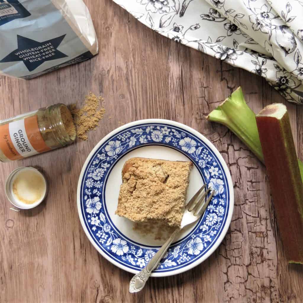 Flat lay image of Rhubarb and Ginger Cake surrounded by ingredients
