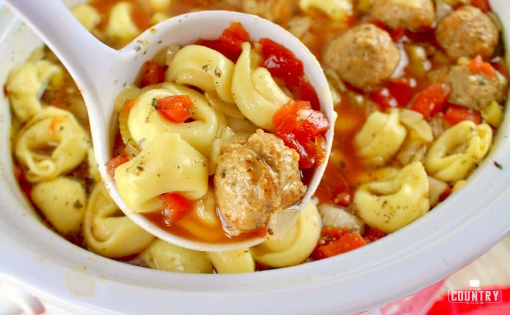 ladle of meatball tortellini soup