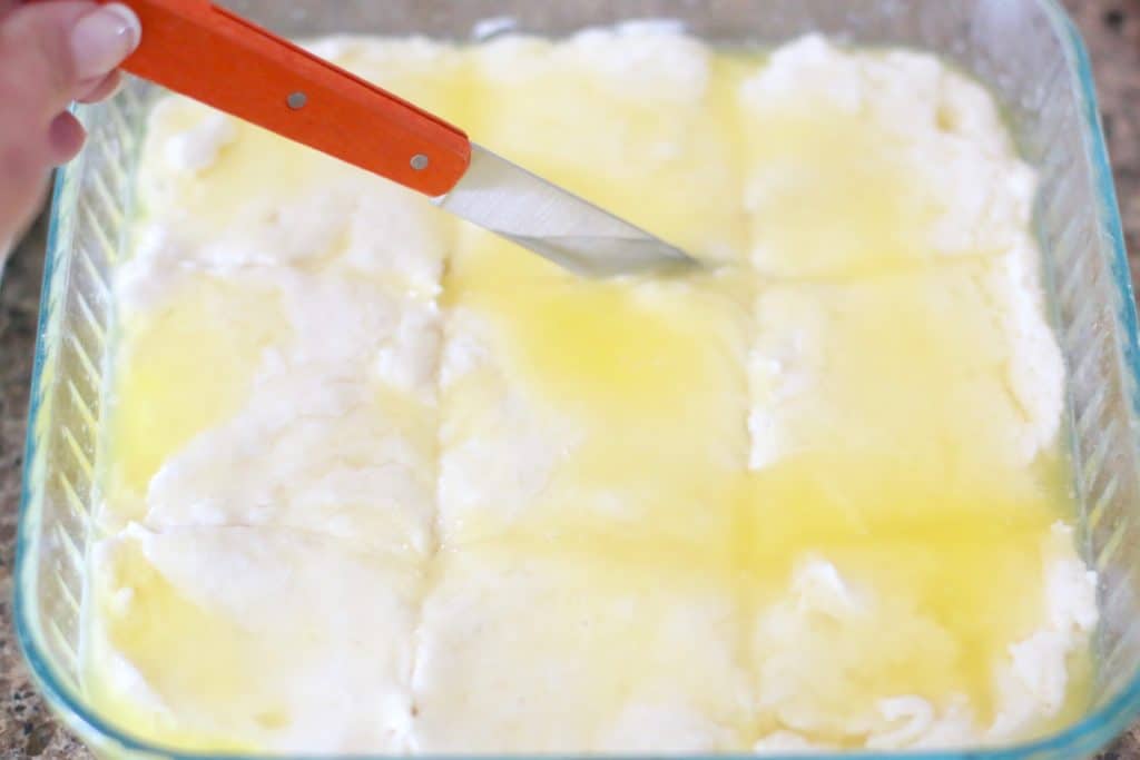knife cutting through biscuit batter and butter