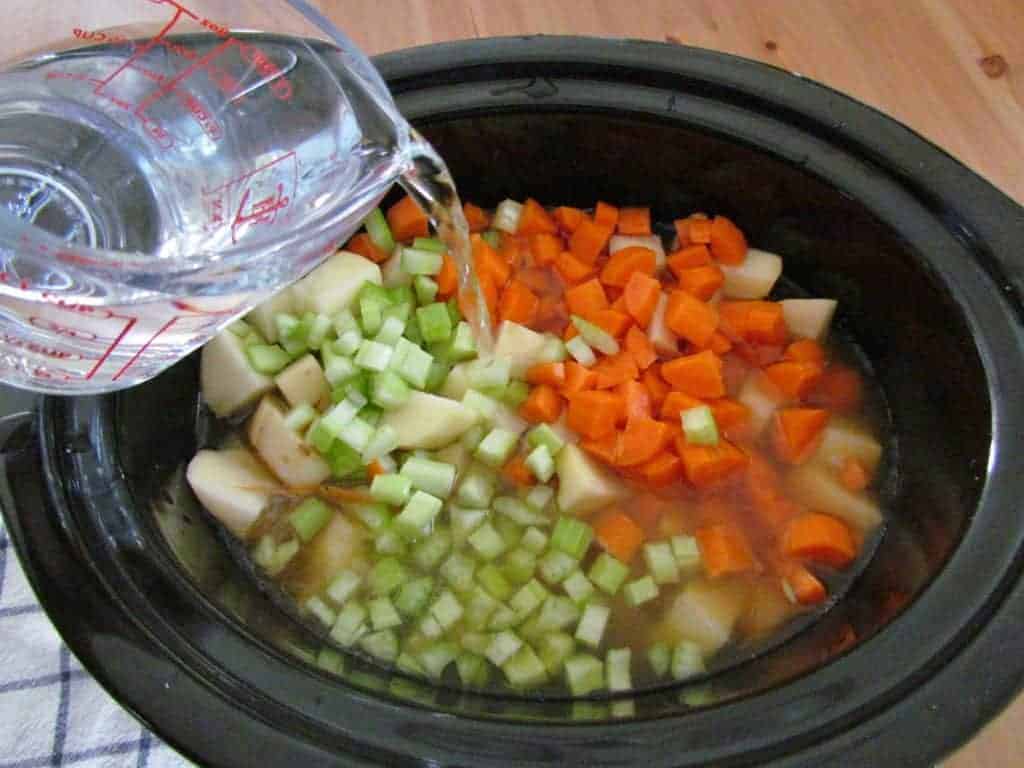 pouring water into 6-quart crock pot